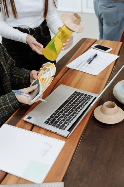 A sleek office desk setup featuring Apple devices: iMac, MacBook, and iPad.