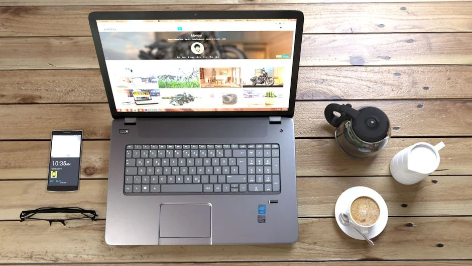 Un poste de travail contemporain avec deux moniteurs affichant des projets de design web, mettant en avant technologie et efficacité.